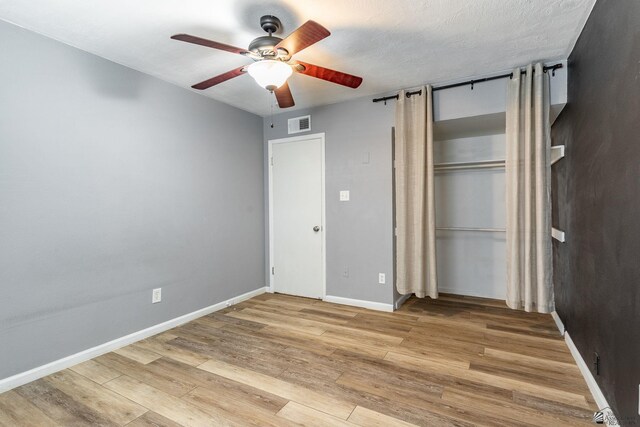 541 E Hacienda Dr, Yuma, AZ 85365 - unfurnished bedroom featuring wood finished floors, baseboards, a closet, and a ceiling fan