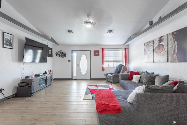 14817 E 49th St, Yuma, AZ 85367 - living room featuring vaulted ceiling, baseboards, and light wood-type flooring