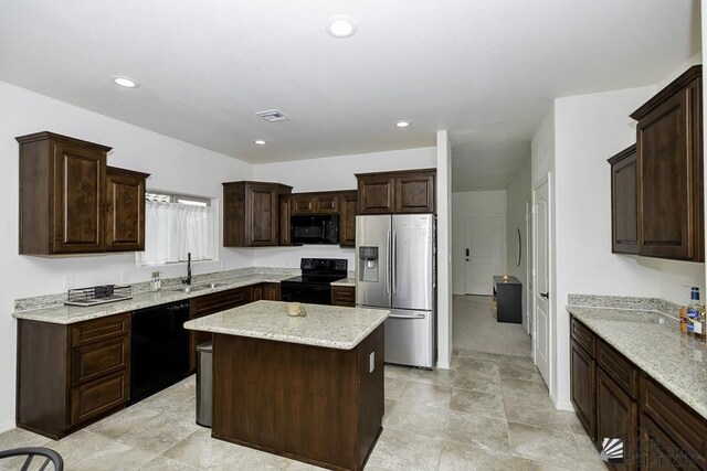 4272 W 27th Pl, Yuma, AZ 85364 - kitchen featuring visible vents, dark brown cabinets, a center island, a sink, and black appliances