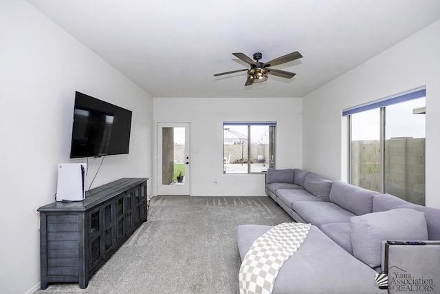 4272 W 27th Pl, Yuma, AZ 85364 - living room featuring baseboards, ceiling fan, light colored carpet, and a wealth of natural light