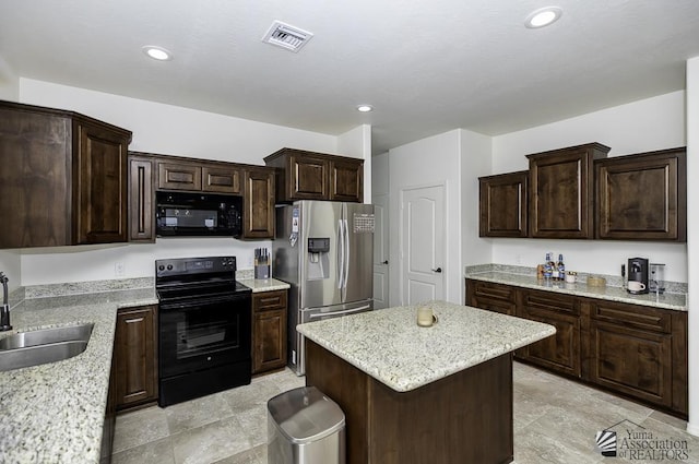 4272 W 27th Pl, Yuma, AZ 85364 - kitchen featuring dark brown cabinetry, a sink, a kitchen island, visible vents, and black appliances
