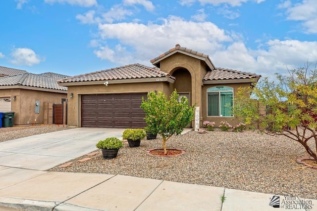 4272 W 27th Pl, Yuma, AZ 85364 - mediterranean / spanish home featuring an attached garage, stucco siding, a tiled roof, and concrete driveway