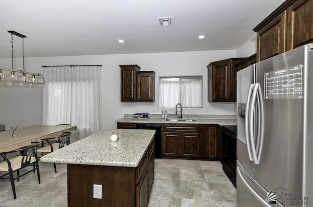 4272 W 27th Pl, Yuma, AZ 85364 - kitchen featuring dark brown cabinetry, light stone counters, a sink, a center island, and black appliances