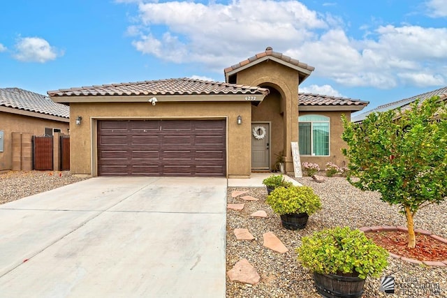 4272 W 27th Pl, Yuma, AZ 85364 - mediterranean / spanish-style house featuring fence, a garage, stucco siding, concrete driveway, and a tiled roof