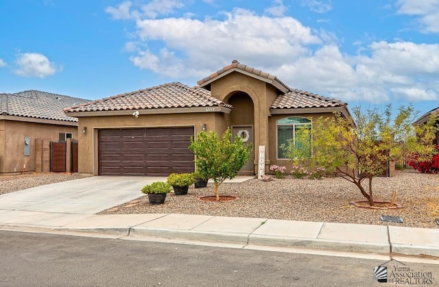 4272 W 27th Pl, Yuma, AZ 85364 - mediterranean / spanish home with a tile roof, a garage, fence, concrete driveway, and stucco siding