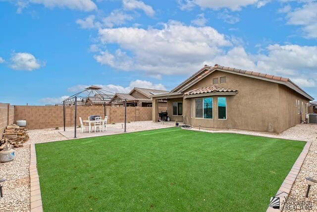 4272 W 27th Pl, Yuma, AZ 85364 - rear view of house with a fenced backyard, a patio, a gazebo, and a lawn