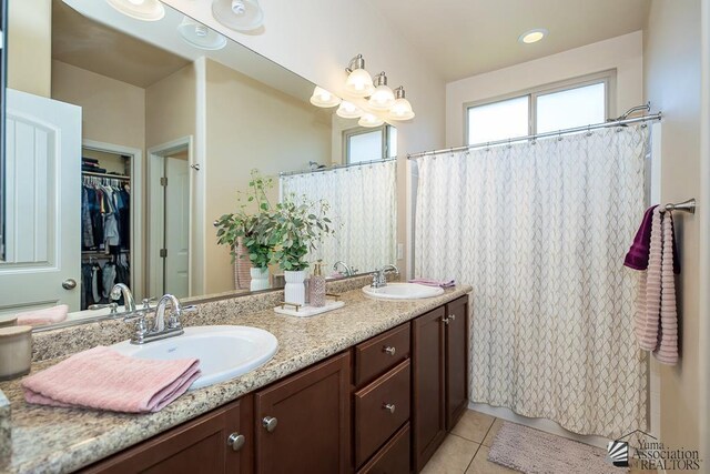 6588 E 35th Pl, Yuma, AZ 85365 - bathroom featuring double vanity, tile patterned floors, a shower with shower curtain, and a walk in closet