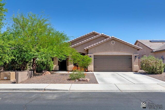 6588 E 35th Pl, Yuma, AZ 85365 - view of front facade with a garage, stucco siding, concrete driveway, and a tile roof