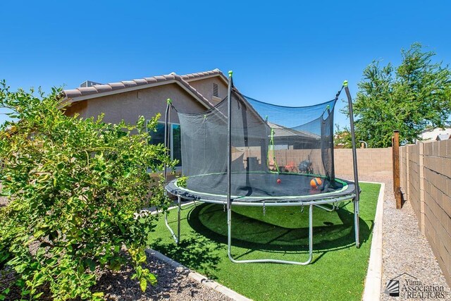 6588 E 35th Pl, Yuma, AZ 85365 - fenced backyard featuring a trampoline