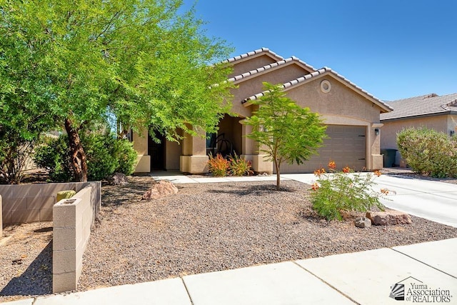 6588 E 35th Pl, Yuma, AZ 85365 - view of front facade with an attached garage, stucco siding, driveway, and a tiled roof
