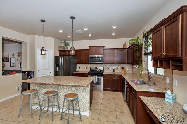 6588 E 35th Pl, Yuma, AZ 85365 - kitchen featuring stainless steel appliances, light tile patterned floors, tasteful backsplash, light stone countertops, and recessed lighting