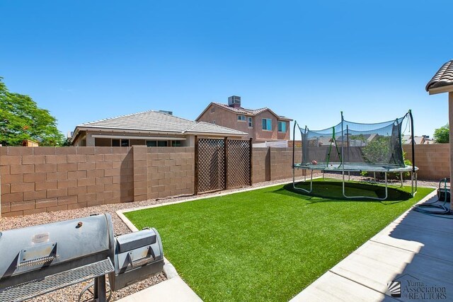 6588 E 35th Pl, Yuma, AZ 85365 - fenced backyard with a trampoline