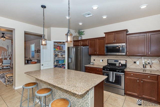 6588 E 35th Pl, Yuma, AZ 85365 - kitchen featuring stainless steel appliances, tasteful backsplash, light tile patterned floors, and recessed lighting