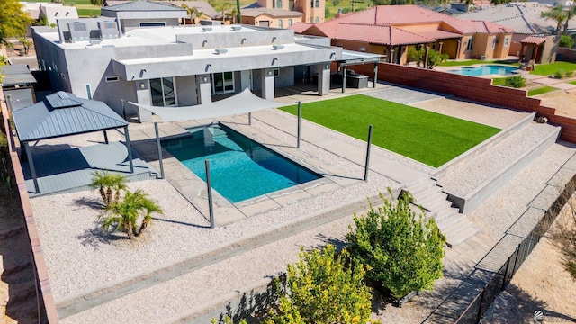 view of pool with a patio, a fenced in pool, a residential view, and a fenced backyard