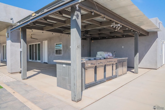 view of patio with a ceiling fan and an outdoor kitchen