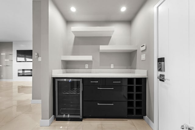 bar with beverage cooler, baseboards, and recessed lighting