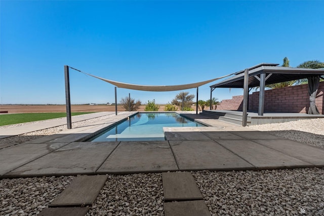 outdoor pool with a gazebo and a patio area