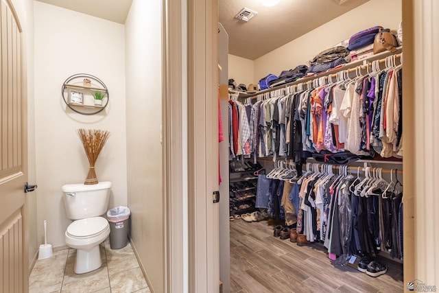 walk in closet featuring visible vents and wood finished floors