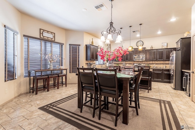 dining area featuring recessed lighting, visible vents, an inviting chandelier, and beverage cooler