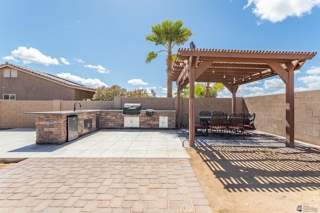 view of patio / terrace with area for grilling, outdoor dining area, a fenced backyard, a pergola, and a sink