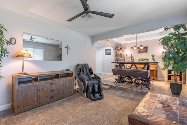 living room with ceiling fan and light colored carpet