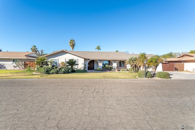 ranch-style home featuring a front yard