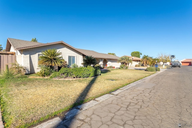 ranch-style home featuring a front lawn