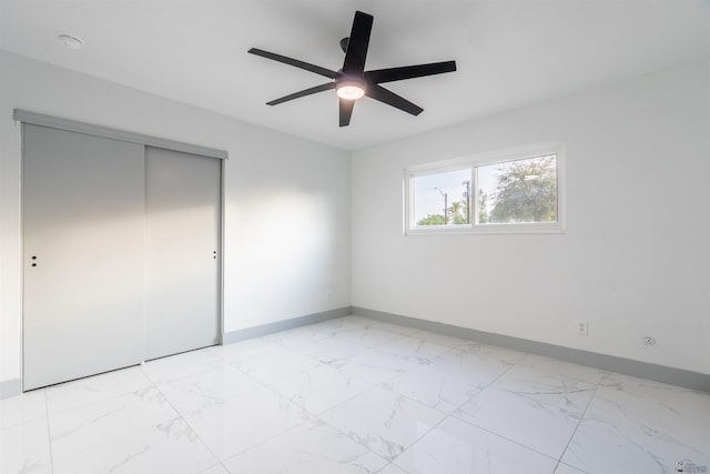 187 S San Clemente Dr, Yuma, AZ 85364 - unfurnished bedroom featuring baseboards, light marble finish flooring, a closet, and a ceiling fan