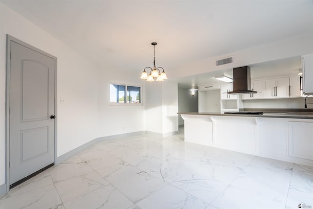 187 S San Clemente Dr, Yuma, AZ 85364 - kitchen featuring island range hood, baseboards, light marble finish flooring, a peninsula, and a chandelier