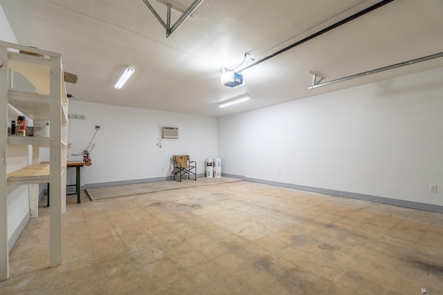 187 S San Clemente Dr, Yuma, AZ 85364 - garage featuring a garage door opener, baseboards, and a wall mounted AC