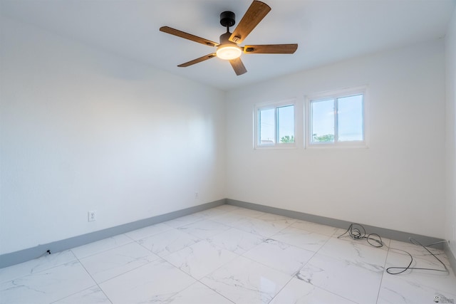 187 S San Clemente Dr, Yuma, AZ 85364 - spare room with baseboards, a ceiling fan, and light marble finish flooring
