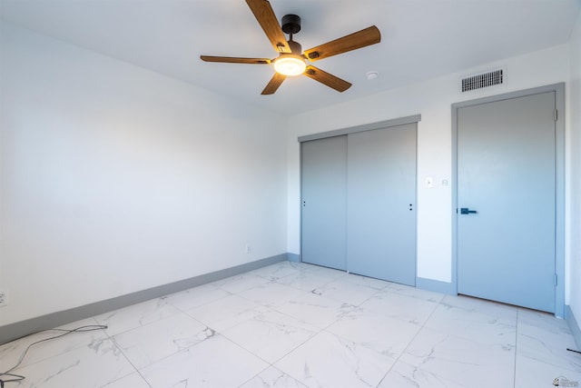 187 S San Clemente Dr, Yuma, AZ 85364 - unfurnished bedroom with light marble finish flooring, a closet, baseboards, and a ceiling fan