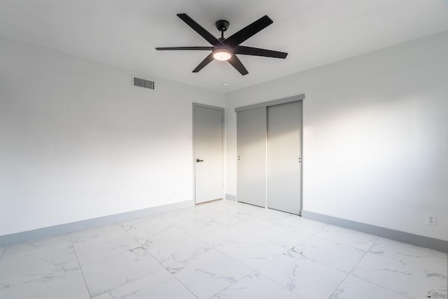 187 S San Clemente Dr, Yuma, AZ 85364 - unfurnished bedroom with baseboards, light marble finish flooring, a closet, and ceiling fan