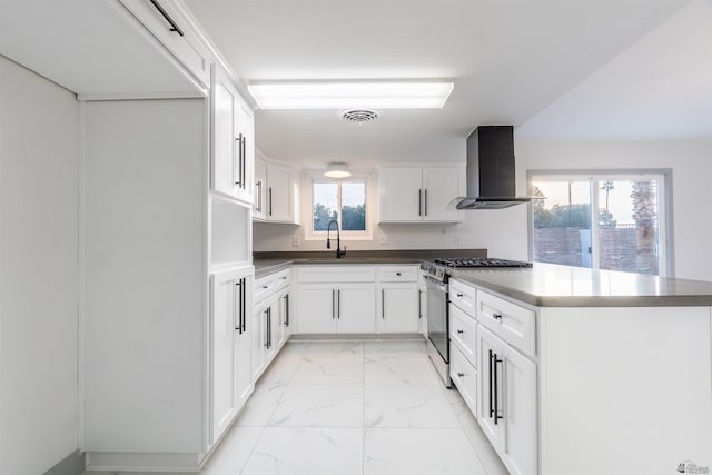 187 S San Clemente Dr, Yuma, AZ 85364 - kitchen with range hood, gas range, light marble finish flooring, a sink, and a peninsula