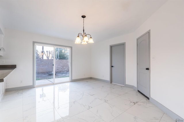 187 S San Clemente Dr, Yuma, AZ 85364 - unfurnished dining area featuring a chandelier, baseboards, and light marble finish flooring