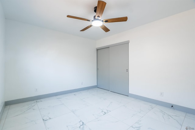 187 S San Clemente Dr, Yuma, AZ 85364 - unfurnished bedroom with light marble finish floors, baseboards, a closet, and a ceiling fan
