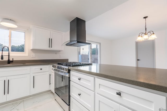 187 S San Clemente Dr, Yuma, AZ 85364 - kitchen with island exhaust hood, stainless steel range with gas stovetop, a sink, light marble finish flooring, and white cabinets