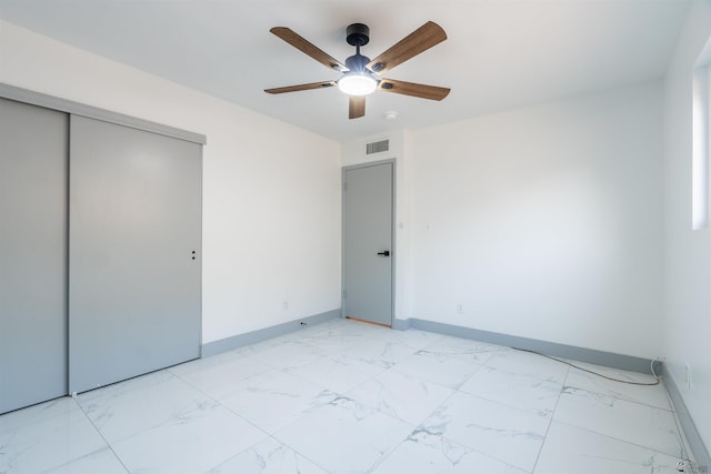 187 S San Clemente Dr, Yuma, AZ 85364 - unfurnished bedroom featuring light marble finish floors, a closet, baseboards, and a ceiling fan