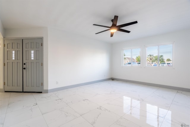 187 S San Clemente Dr, Yuma, AZ 85364 - empty room featuring baseboards, light marble finish flooring, and a ceiling fan