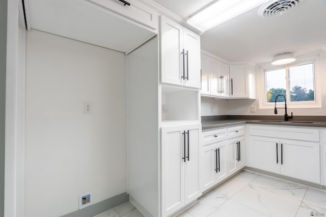 187 S San Clemente Dr, Yuma, AZ 85364 - kitchen featuring a sink, light marble finish floors, dark countertops, and white cabinets
