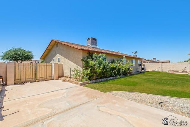 7442 E 24th Ln, Yuma, AZ 85365 - rear view of house with a patio, cooling unit, stucco siding, a chimney, and a gate