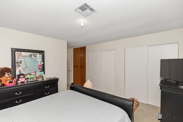 7442 E 24th Ln, Yuma, AZ 85365 - bedroom featuring two closets and light colored carpet