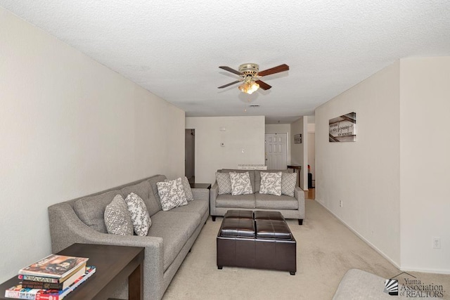 7442 E 24th Ln, Yuma, AZ 85365 - carpeted living area with a ceiling fan, baseboards, and a textured ceiling