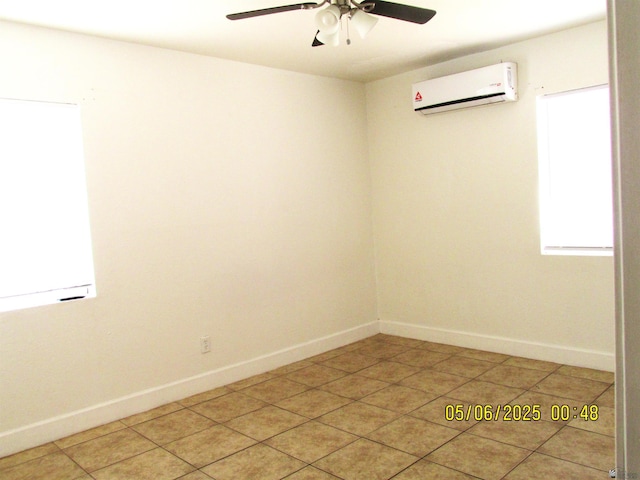 1429 S 12th Dr, Yuma, AZ 85364 - spare room with a wall unit AC, a ceiling fan, baseboards, and light tile patterned floors