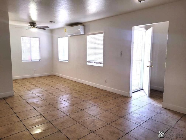 1429 S 12th Dr, Yuma, AZ 85364 - empty room featuring a wall unit AC, a ceiling fan, light tile patterned floors, and baseboards