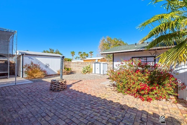 13734 E 47th Dr, Yuma, AZ 85367 - view of patio / terrace featuring fence, a storage unit, and an outdoor structure