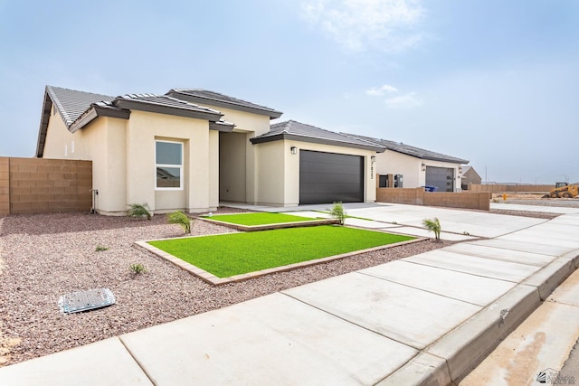 view of front of home featuring fence, an attached garage, stucco siding, concrete driveway, and a tiled roof