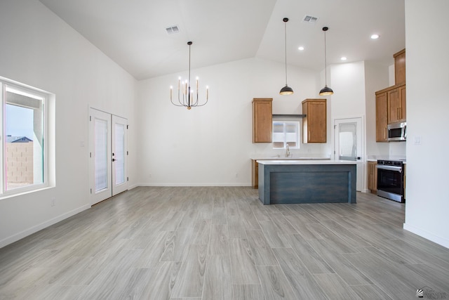 kitchen featuring appliances with stainless steel finishes, a notable chandelier, high vaulted ceiling, and visible vents