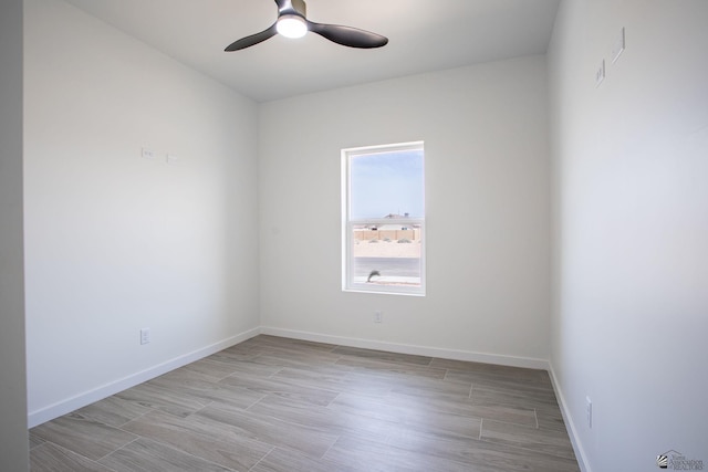 unfurnished room featuring baseboards, ceiling fan, and wood finished floors