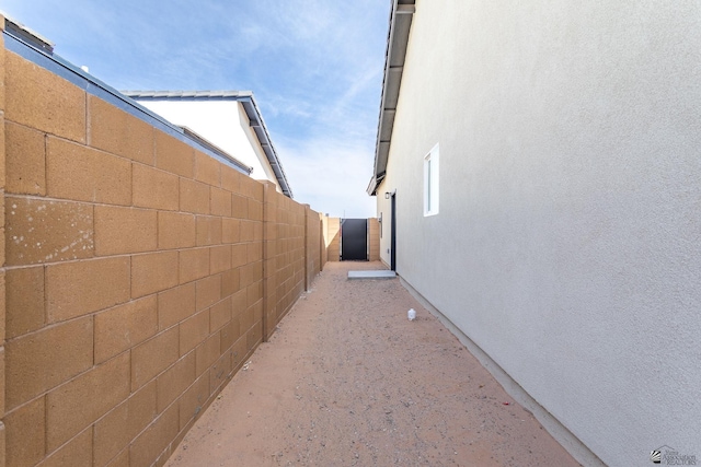 view of property exterior with fence and stucco siding